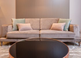 ANASAYFA Stylish living room with cozy couch with soft pillows and round coffee table